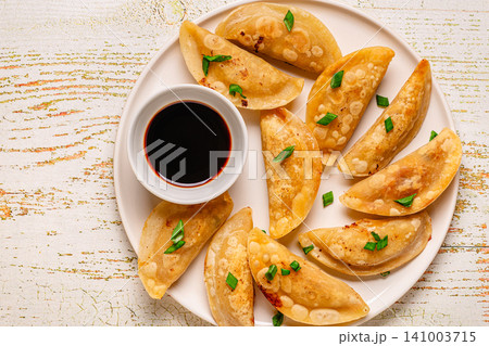Dumplings served on a plate with soy sauce Dumplings served on a plate with soy sauce 141003715