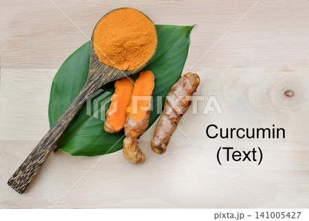 Turmeric powder in a wooden spoon and fresh turmeric roots on a wooden plate with copy space for text, highlighting natural herbal ingredients, organic wellness, and healthy nutrition concepts. Turmeric powder in a wooden spoon and fresh turmeric roots on a wooden plate with copy space for text, highlighting natural herbal ingredients, organic wellness, and healthy nutrition concepts. 141005427