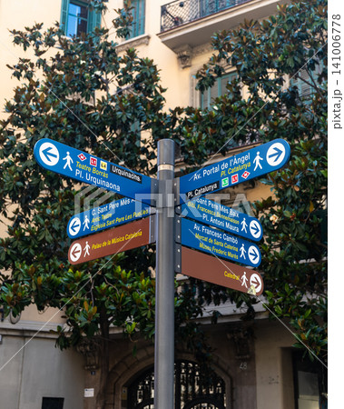 A multi-directional signpost stands in Barcelona, indicating routes to Teatre Borras, Placa Catalunya, the Cathedral, and Palau de la Musica Catalana. A multi-directional signpost stands in Barcelona, indicating routes to Teatre Borras, Placa Catalunya, the Cathedral, and Palau de la Musica Catalana. 141006778