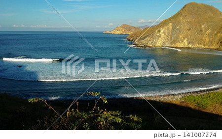 A beautiful view of the blue sea and hills in Lombok, Indonesia. A beautiful view of the blue sea and hills in Lombok, Indonesia. 141007274
