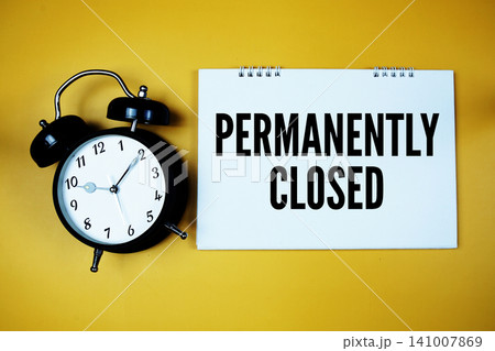 Permanently Closed text with alarm clock on yellow background Permanently Closed text with alarm clock on yellow background 141007869