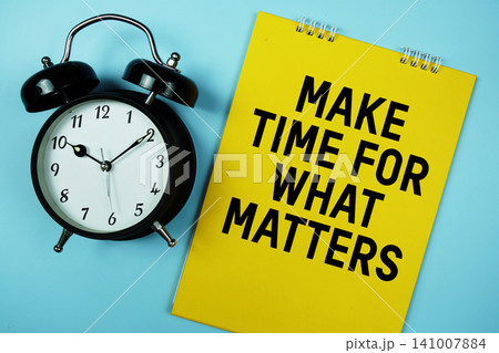 Make Time For What Matters text with alarm clock on blue background 141007884