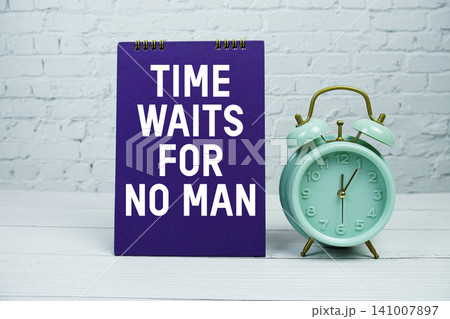 Time Waits For No Man text with Mint Green Alarm Clock on wooden Background 141007897