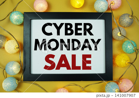 Cyber Monday Sale text with LED cotton balls decoration on yellow background Cyber Monday Sale text with LED cotton balls decoration on yellow background 141007907