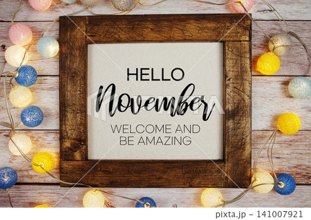 Hello November text with LED cotton ball decoration on wooden background Hello November text with LED cotton ball decoration on wooden background 141007921