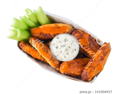 crunchy buffalo chicken wings with celery sticks and blue cheese dipping sauce in paper tray isolated on white background, top view. crunchy buffalo chicken wings with celery sticks and blue cheese dipping sauce in paper tray isolated on white background, top view. 141008457