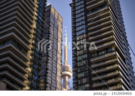 CN Tower Peeks Between Two Dark Glass Skyscrapers Toronto Canada CN Tower Peeks Between Two Dark Glass Skyscrapers Toronto Canada 141009468