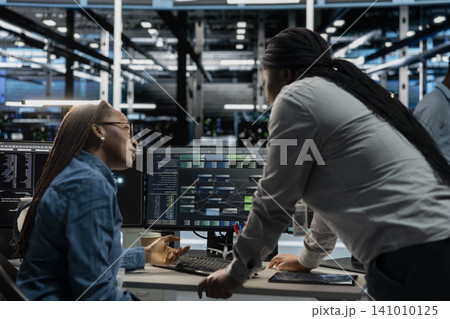 Server facility supervisor supervising technical work from systems engineer applying AI neural network models. Server facility supervisor supervising technical work from systems engineer applying AI neural network models. 141010125