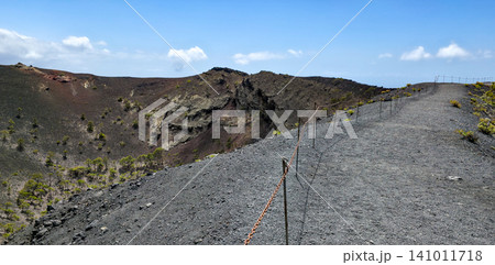 A walk along the edge of the crater of the San Antonio volcano on the Canary Island of La Palma along the tourist trail. High quality photo A walk along the edge of the crater of the San Antonio volcano on the Canary Island of La Palma along the tourist trail. High quality photo 141011718