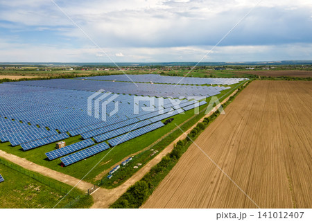 Aerial view of big sustainable electric power plant with many rows of solar photovoltaic panels for producing clean ecological electrical energy. Renewable electricity with zero emission concept. 141012407