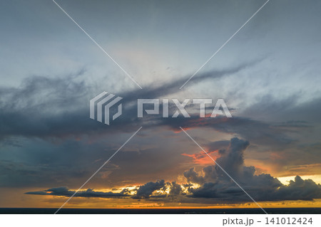 White fluffy cumulonimbus clouds forming before thunderstorm on evening sky. Changing stormy cloudscape weather at sunset White fluffy cumulonimbus clouds forming before thunderstorm on evening sky. Changing stormy cloudscape weather at sunset 141012424