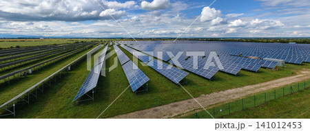 Aerial view of big sustainable electric power plant with many rows of solar photovoltaic panels for producing clean electrical energy. Renewable electricity with zero emission concept 141012453