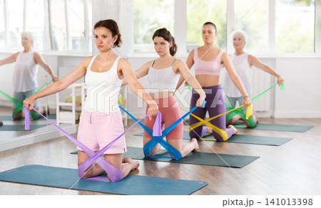 Adult woman exercising with pilates band Adult woman exercising with pilates band 141013398