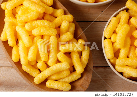 Crispy corn sticks in a wooden dish on a rustic table Crispy corn sticks in a wooden dish on a rustic table 141013727