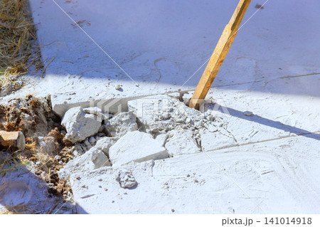 Workers break concrete slab at construction site with hammer tools. Workers break concrete slab at construction site with hammer tools. 141014918