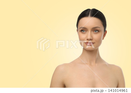 Woman poses gracefully with natural beauty against a soft background Woman poses gracefully with natural beauty against a soft background 141014961