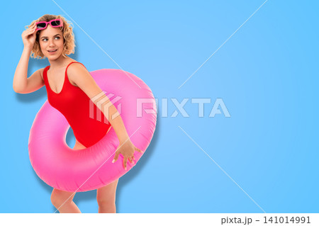 Woman poses in pink inflatable ring. Summer fashion and vacation concept 141014991