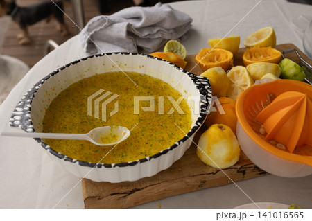 citrus juice preparation on a kitchen counter with vibrant colors and fresh ingredients, close-up view of juicer and squeezed peels, healthy lifestyle and food preparation context. citrus juice preparation on a kitchen counter with vibrant colors and fresh ingredients, close-up view of juicer and squeezed peels, healthy lifestyle and food preparation context. 141016565