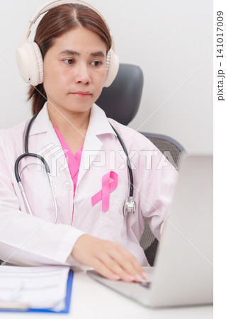 Professional doctor using laptop for telehealth, telemedical, online consultation and video meeting about Breast Cancer Awareness month, World Cancer Day and Pink October in hospital office concept Professional doctor using laptop for telehealth, telemedical, online consultation and video meeting about Breast Cancer Awareness month, World Cancer Day and Pink October in hospital office concept 141017009