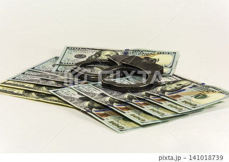 Metal handcuffs on banknotes US dollars 141018739