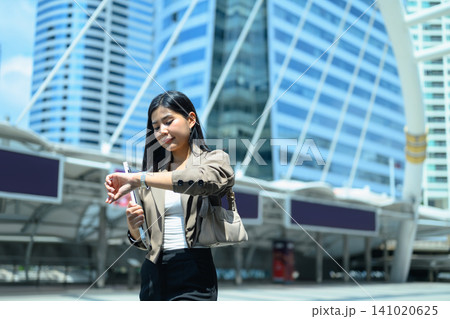 In a rush businesswoman looking her watch in city urban In a rush businesswoman looking her watch in city urban 141020625