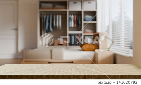3D Illustration of Empty Wooden Table Top with Blurred Bedroom Wardrobe and Shelving Unit Background 141020792