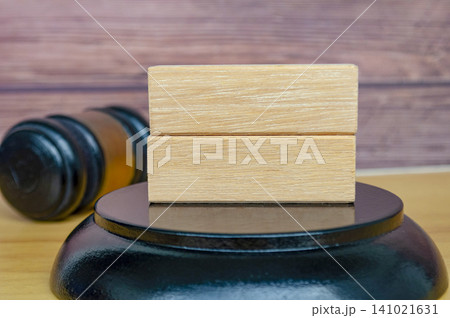 Blank Wooden Square Sign with Gavel and Gold Band in Background. Blank Wooden Square Sign with Gavel and Gold Band in Background. 141021631