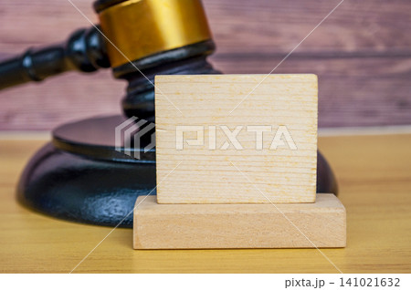 Raised Gavel with Gold Band and Blank Wooden Square Plaque Closeup. 141021632