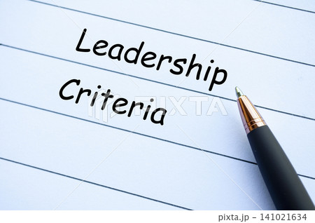 Leadership Criteria Handwritten Text on Notebook Paper with Pen. Leadership Criteria Handwritten Text on Notebook Paper with Pen. 141021634