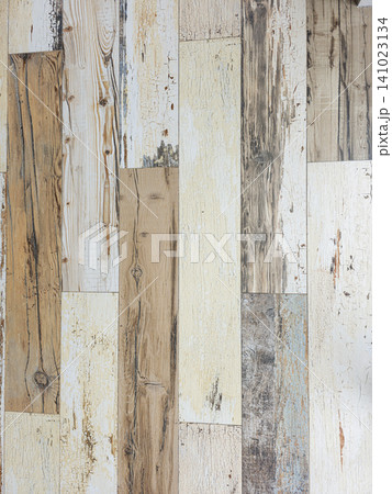 Rustic wooden planks create a vertical pattern with distressed paint in multiple colors. The background shows vintage textures that add detail to the wood surface. Rustic wooden planks create a vertical pattern with distressed paint in multiple colors. The background shows vintage textures that add detail to the wood surface. 141023134
