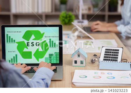Business person working on laptop with ESG screen for corporate sustainability 141023223