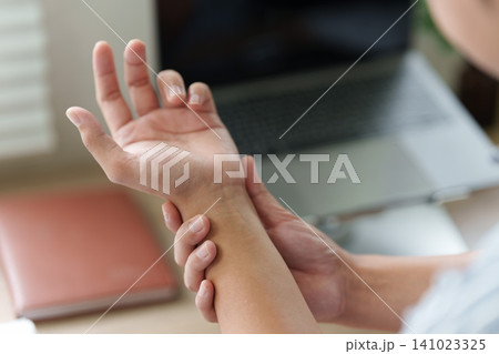 Cropped hand massaging painful wrist for carpal tunnel syndrome concept Cropped hand massaging painful wrist for carpal tunnel syndrome concept 141023325