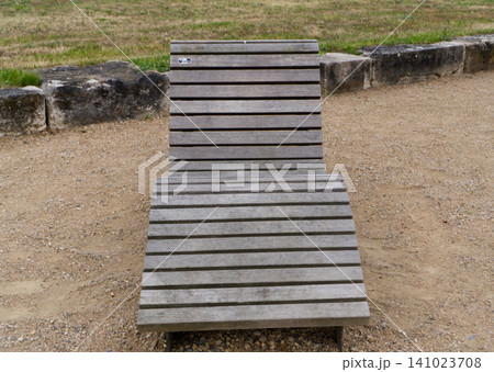Wooden sun lounger on beach 141023708