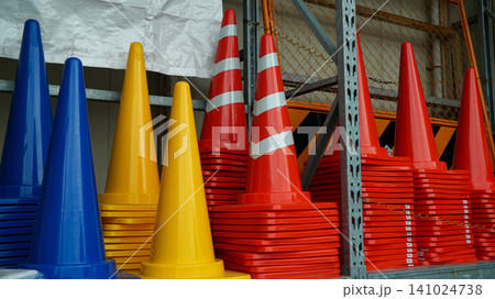 Colorful traffic cones in stacks at an industrial warehouse 141024738