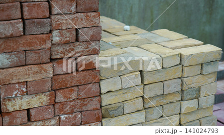 Stacked red and yellow clay bricks at a construction yard Stacked red and yellow clay bricks at a construction yard 141024793