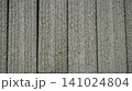 Textured grey concrete wall panels with vertical grooves 141024804