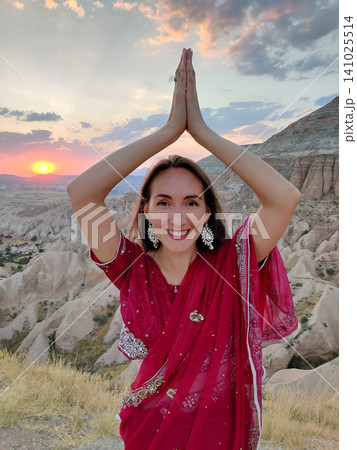 beautiful girl in national Indian clothes on the background of mountains beautiful girl in national Indian clothes on the background of mountains 141025514