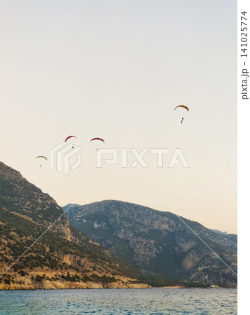 beautiful landscape with a view of the sea flying on a paraglider beautiful landscape with a view of the sea flying on a paraglider 141025774