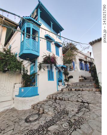 Traditional white Mediterranean houses with blue balconies on a cobblestone street in Marmaris Turkey Traditional white Mediterranean houses with blue balconies on a cobblestone street in Marmaris Turkey 141025790