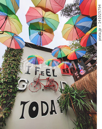 Creative wall decor with rainbow umbrellas and a red vintage bicycle Creative wall decor with rainbow umbrellas and a red vintage bicycle 141025794