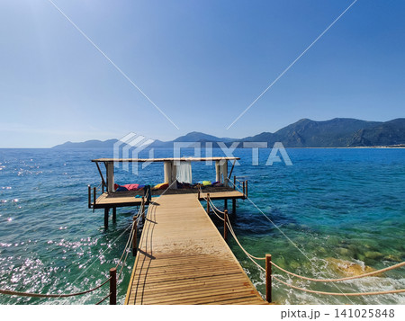 beautiful bungalows for relaxation in the middle of the water with a path from the beach beautiful bungalows for relaxation in the middle of the water with a path from the beach 141025848