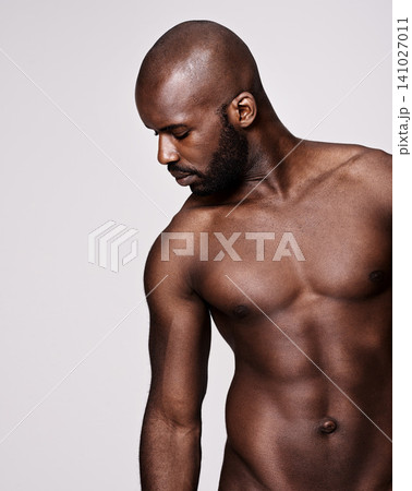Black man, model and fitness with muscular body for fashion or masculine figure on a gray studio background. Attractive African, male person or bodybuilder with muscle for strength on mockup space Black man, model and fitness with muscular body for fashion or masculine figure on a gray studio background. Attractive African, male person or bodybuilder with muscle for strength on mockup space 141027011