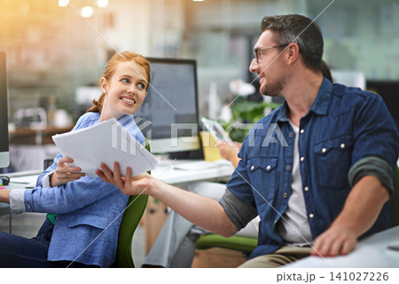 Business people, paperwork and teamwork with conversation, solution or cooperation with problem solving. Journalist, magazine or man with woman or documents and editor with planning, report or review Business people, paperwork and teamwork with conversation, solution or cooperation with problem solving. Journalist, magazine or man with woman or documents and editor with planning, report or review 141027226