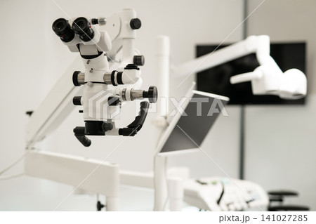 Professional white dental operating microscope in a modern clinic 141027285