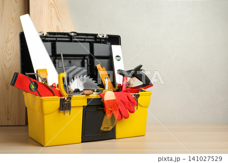 Box with different carpenter's tools on wooden table. Space for text 141027529