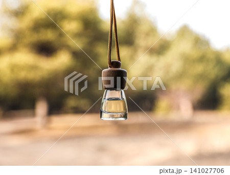 Car air freshener hanging on blurred view, closeup Car air freshener hanging on blurred view, closeup 141027706