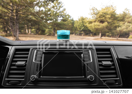 Stylish air freshener on dashboard in car 141027707