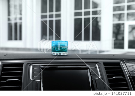 Stylish air freshener on dashboard in car 141027711