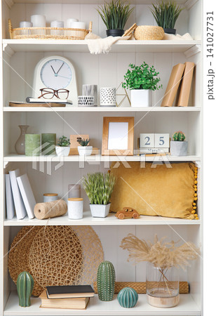 White shelving unit with plants and different decorative stuff White shelving unit with plants and different decorative stuff 141027731