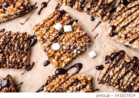 Delicious rice crispy treats on parchment paper, flat lay Delicious rice crispy treats on parchment paper, flat lay 141027814